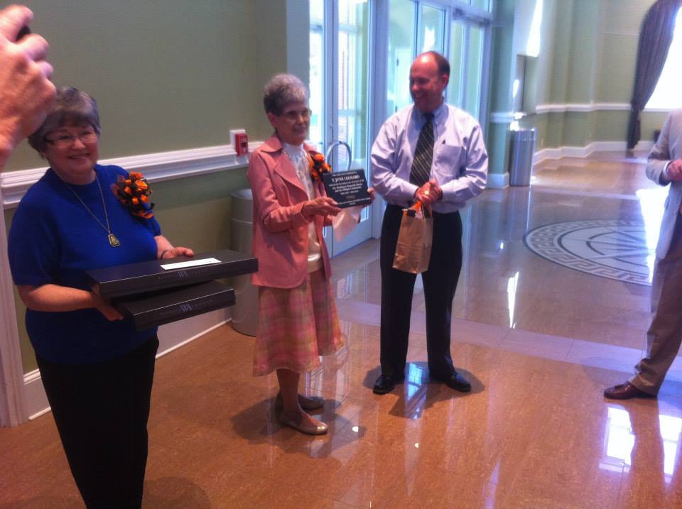 Vice President for Institutional Advancement Jack Simpson presents plaque to June Leonard